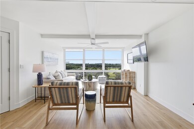 Dining room with beam ceiling, light wood-style floors, and a ceiling fan