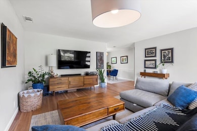 Living room featuring wood finished floors and ba