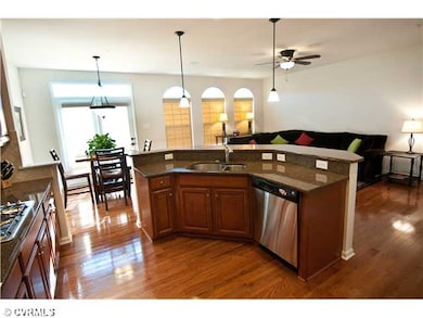 Kitchen - Island has bar height seating and pendan