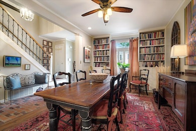 Dining space with hardwoods, a ceiling fan, crown molding, and built in features