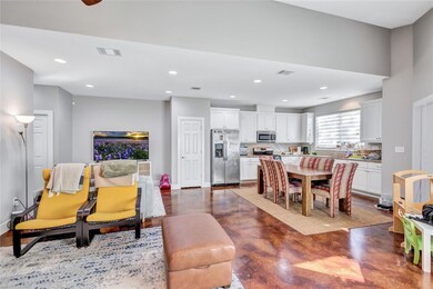 Living area with finished concrete flooring and r