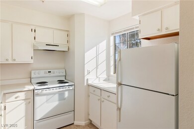 Kitchen with white appliances, under cabinet range