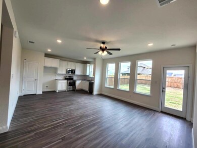 Unfurnished living room with ceiling fan and dark wood-type flooring