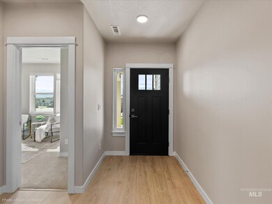Entrance foyer featuring light wood-type flooring and baseboards