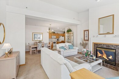 As you enter the front door, you are greeted to an open living room with gas fireplace