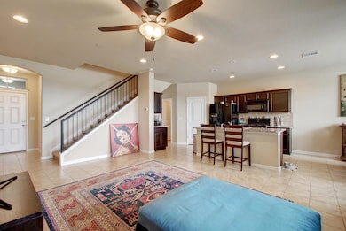 Living area with light tile patterned floors, vis