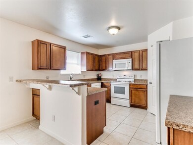 Kitchen with kitchen peninsula, light tile pattern