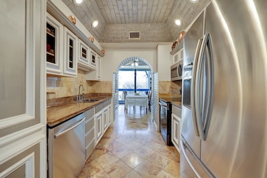 The spacious kitchen with granite countertops, amp