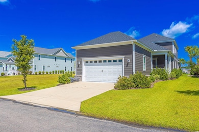 View of front of house featuring a front lawn, a garage, concrete driveway, and a shingled roof