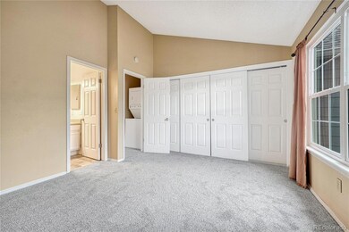 Large primary bedroom with vaulted ceiling.