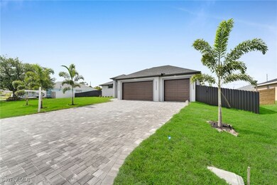 Garage featuring decorative driveway