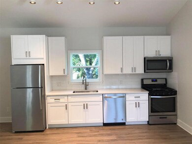 Kitchen featuring a sink, backsplash, white cabin