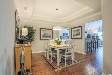 with tray ceiling, beautiful chandelier, and crown