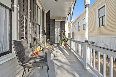 Large entry porch with beautiful wood shutters on