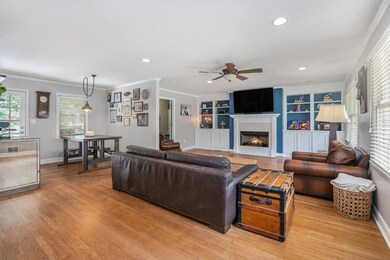 Step inside to a spacious Open Concept Living Area highlighted by Hardwood Floors, Crown Molding, Recessed Lighting, and Custom Built-Ins flanking the Fireside Living Room the true Heart of the Home.