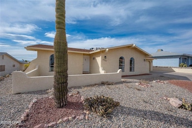 Ranch-style home featuring stucco siding and fence