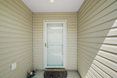 Covered front entrance with storm door