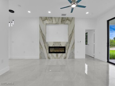 Unfurnished living room with marble tiled flooring