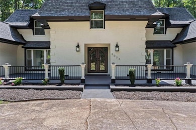 Doorway to property featuring brick siding, french