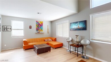 Living room featuring visible vents, baseboards, a