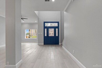 Foyer featuring crown molding, light wood finished floors, recessed lighting, and a ceiling fan
