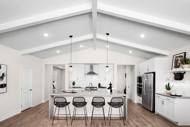 Kitchen with vaulted ceiling and white-painted ceiling beams