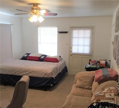 Bedroom featuring a ceiling fan and carpet