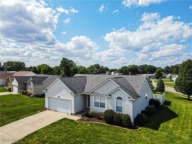 Ranch-style house with a front lawn and a garage