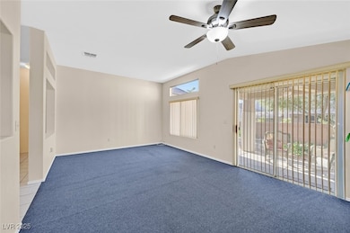Empty room featuring carpet floors, lofted ceiling, and ceiling fan