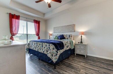 Bedroom featuring wood finished floors, baseboard