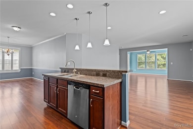Kitchen with dishwasher, open floor plan, dark wood-type flooring, a chandelier, and ornamental molding