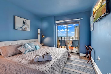 Bedroom featuring access to exterior and hardwood 