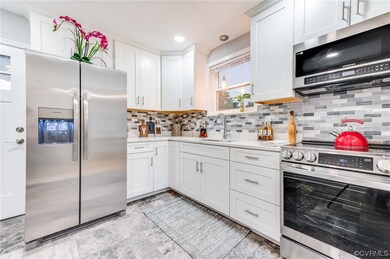 Kitchen featuring stainless steel appliances, whit
