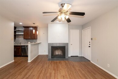 Unfurnished living room featuring ceiling fan, wo