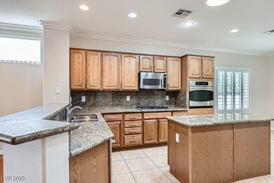 Kitchen with visible vents, a sink, crown molding,