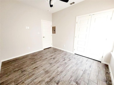 Unfurnished bedroom with light wood-style floors, a ceiling fan, and a closet