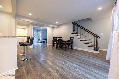 Dining space with stairway, dark wood-style flooring, and recessed lighting