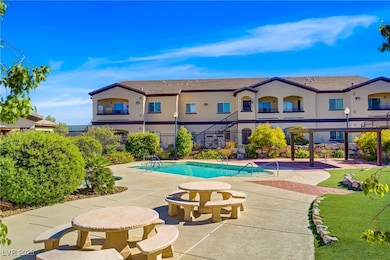 Community pool featuring a balcony and a patio