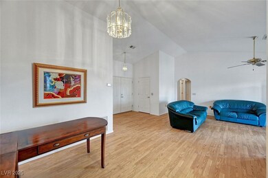Sitting room featuring high vaulted ceiling, arche