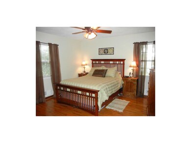 Master bedroom with remote fan and hardwood floors