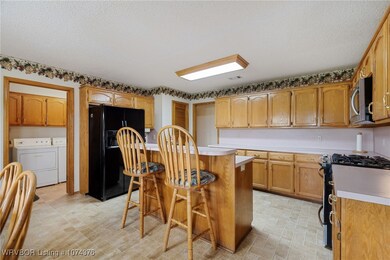 Kitchen with bar and laundry area