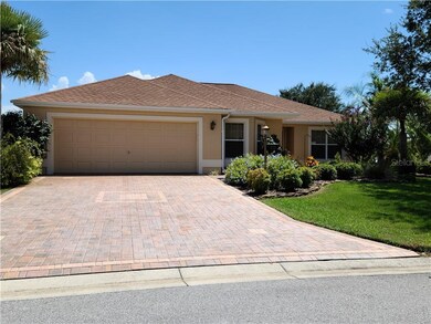 WELCOMING ENTRY FEATURES A PAVER DRIVE AND WALK