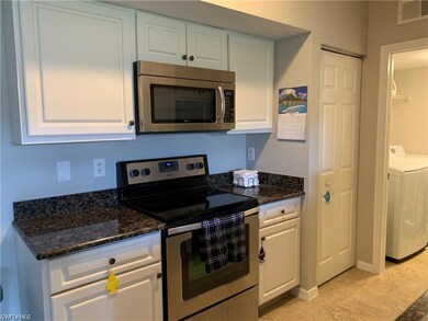 Kitchen with stainless steel appliances, white cab