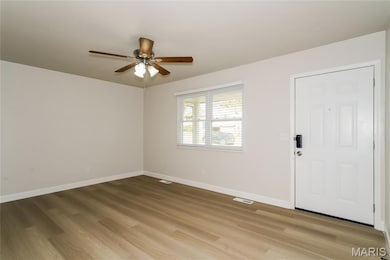 Entrance foyer featuring light wood-type flooring and a ceiling fan