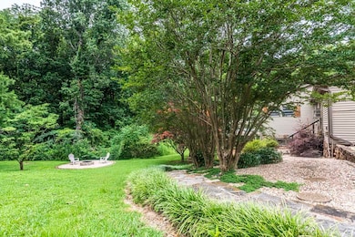 View of grassy yard featuring a fire pit