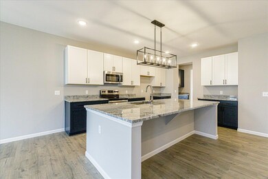 Large Island with Seating and Granite Countertops 