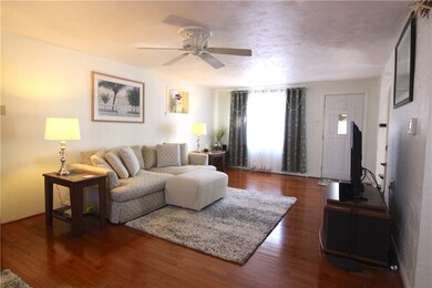Livingroom is flanked by windows and features a ce