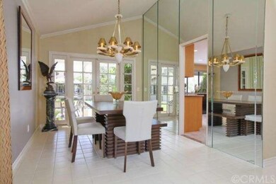 Formal dining room with mirrored wall and French d