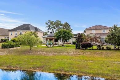 Back of property featuring a yard, fence, and a wa