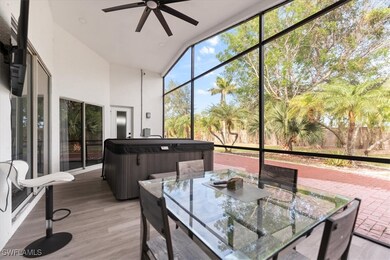 Sunroom / solarium with ceiling fan and a hot tub